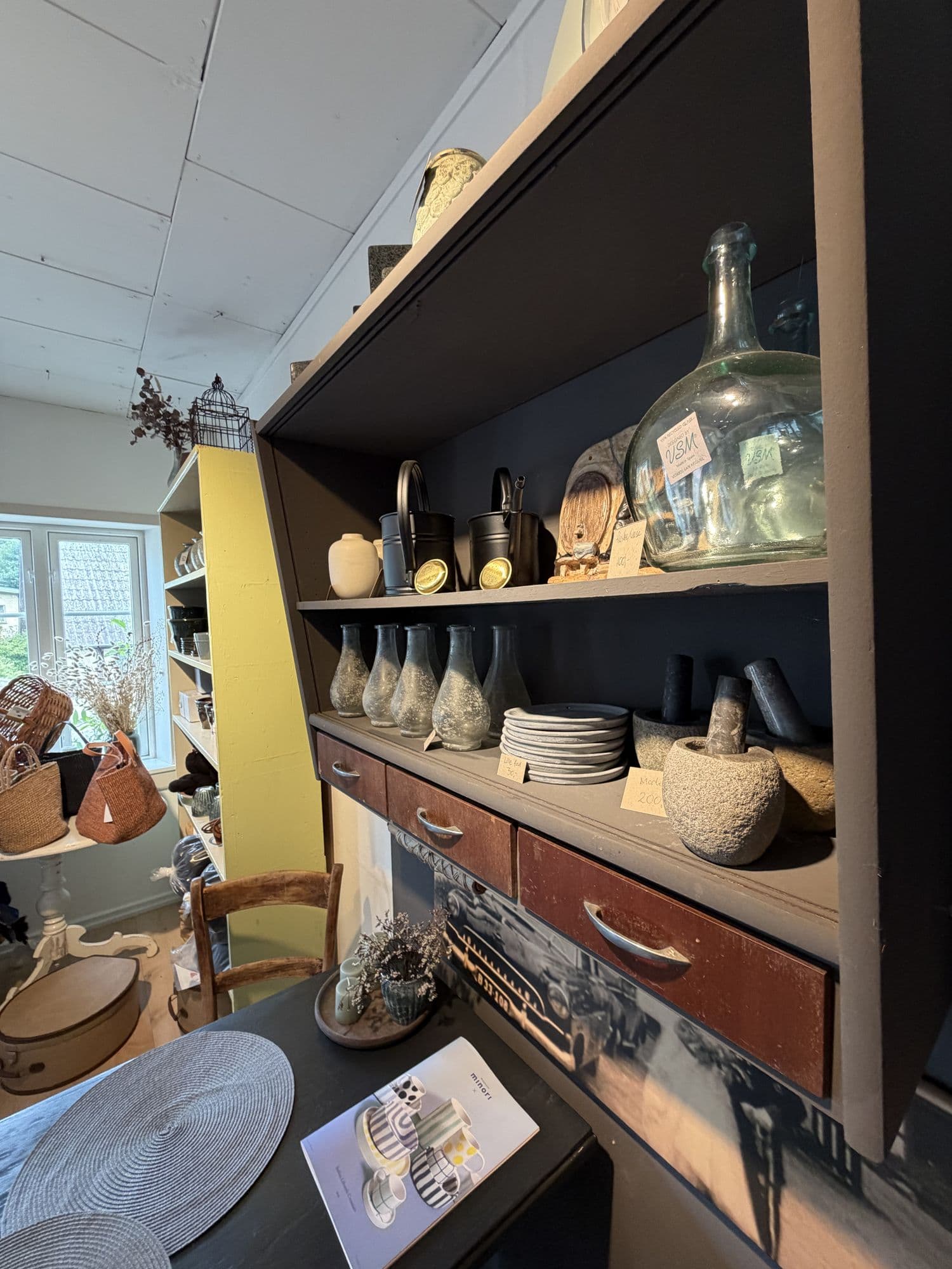 Skuffe med gamle flasker og glas i butikken
